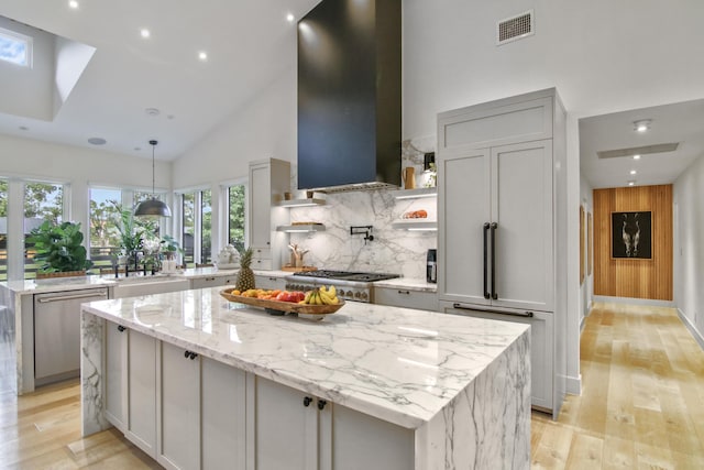 kitchen featuring appliances with stainless steel finishes, visible vents, gray cabinetry, and exhaust hood