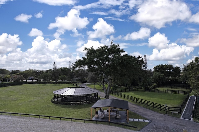 surrounding community featuring a yard, a rural view, fence, and a gazebo