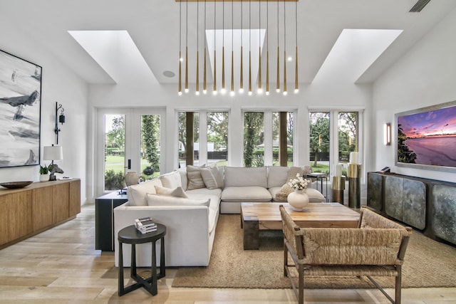 living room with visible vents, plenty of natural light, and light wood-style flooring