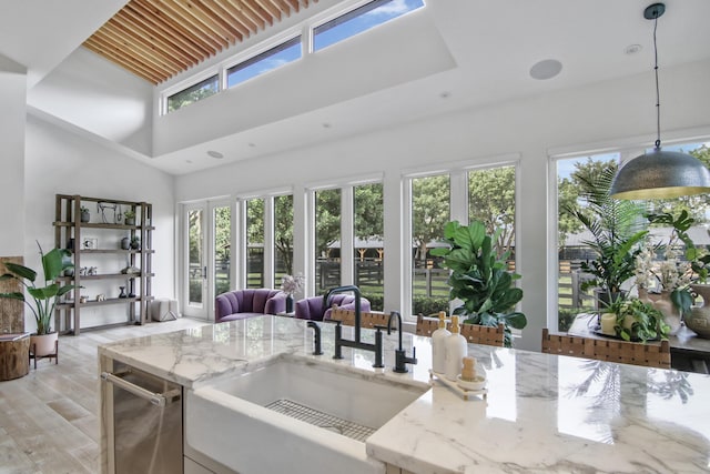 sunroom with a healthy amount of sunlight and a sink