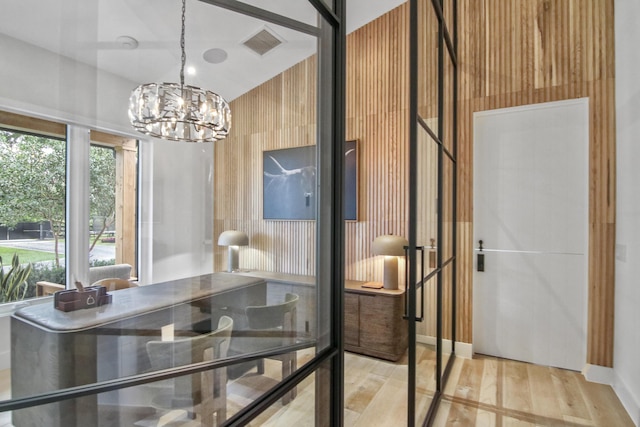 dining room featuring light wood finished floors, visible vents, and a chandelier