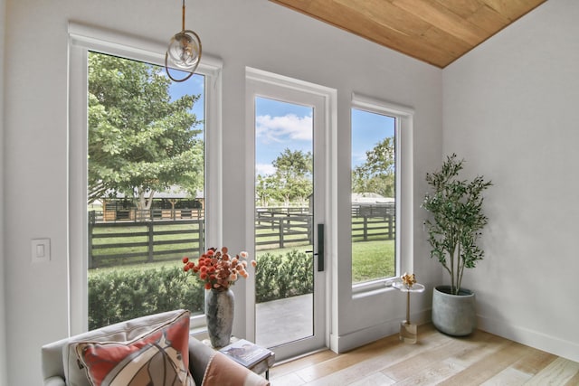 doorway to outside with wooden ceiling, baseboards, and wood finished floors