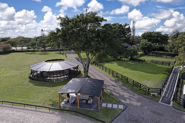 surrounding community featuring a rural view, fence, a lawn, and a gazebo