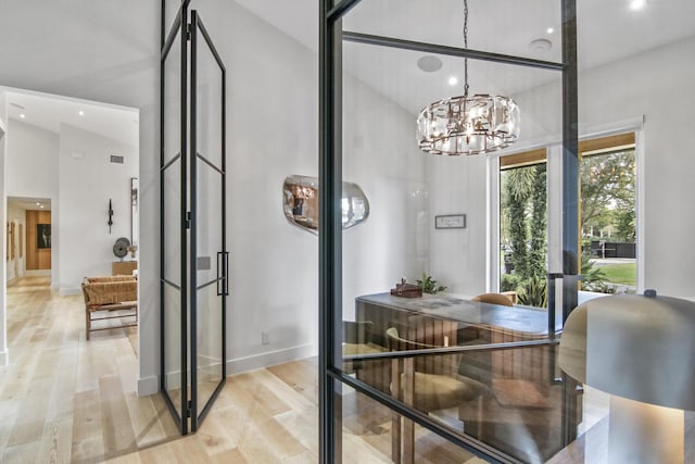 dining room featuring high vaulted ceiling, light wood-style flooring, recessed lighting, baseboards, and an inviting chandelier