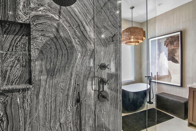 bathroom featuring a freestanding tub and a marble finish shower