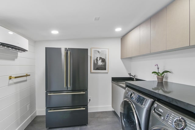 washroom with recessed lighting, a sink, baseboards, independent washer and dryer, and a wall mounted air conditioner