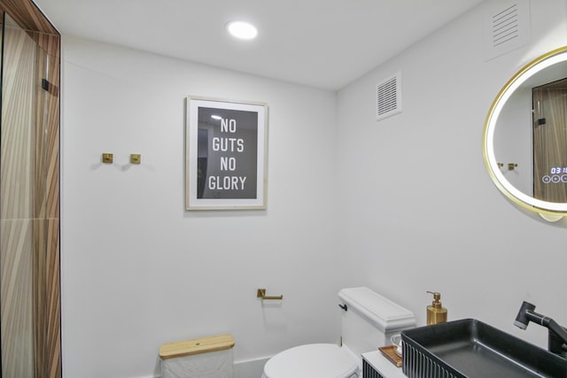 bathroom with toilet, visible vents, a sink, and recessed lighting