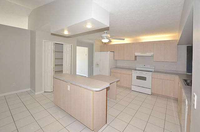 kitchen with white appliances, light tile patterned floors, a kitchen island, and light brown cabinets