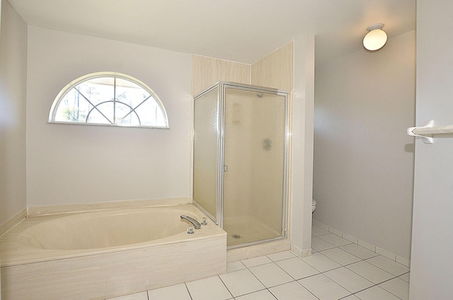 bathroom featuring tile patterned flooring, plus walk in shower, and toilet