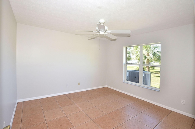 tiled spare room featuring ceiling fan and a textured ceiling