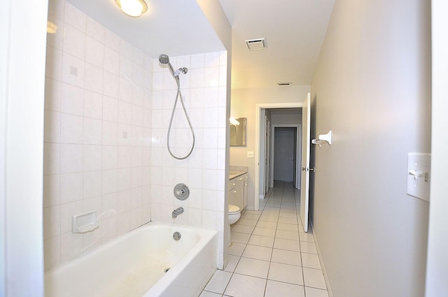 full bathroom featuring tiled shower / bath, vanity, toilet, and tile patterned flooring