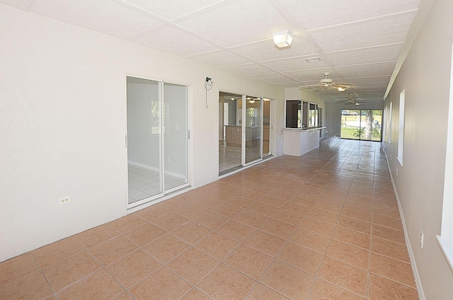 unfurnished room with ceiling fan and tile patterned flooring