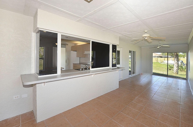 unfurnished sunroom with coffered ceiling and sink