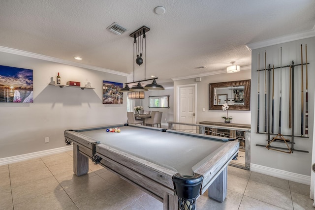 game room with a textured ceiling, ornamental molding, pool table, and light tile patterned flooring