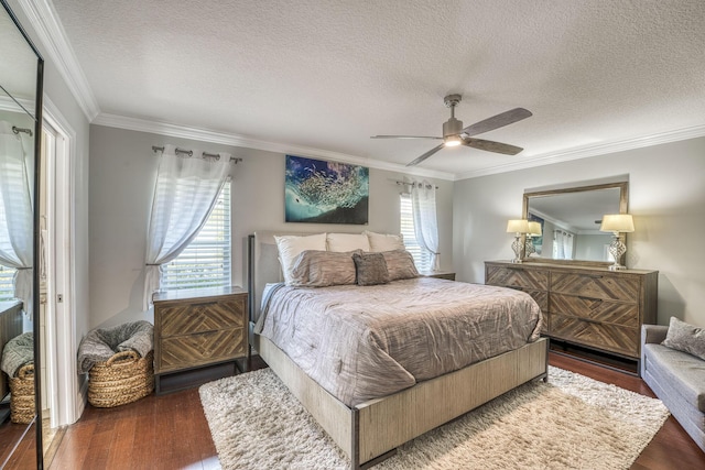 bedroom featuring a textured ceiling, dark wood-type flooring, crown molding, and ceiling fan