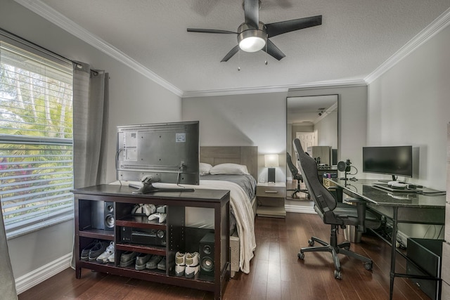 bedroom with ceiling fan, ornamental molding, dark wood-type flooring, and a textured ceiling