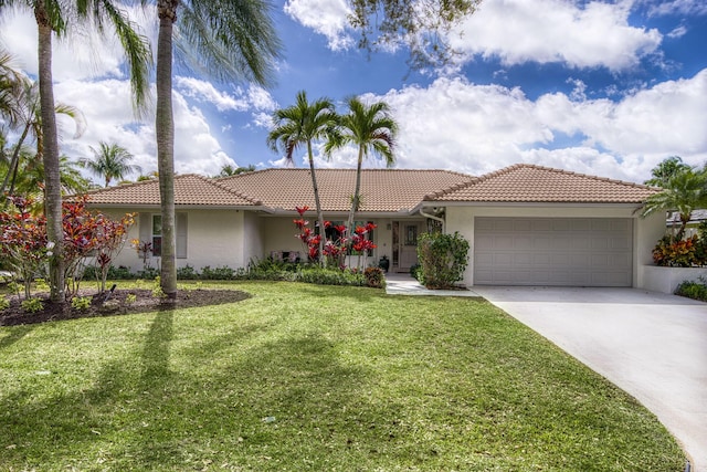 view of front of house featuring a garage and a front lawn