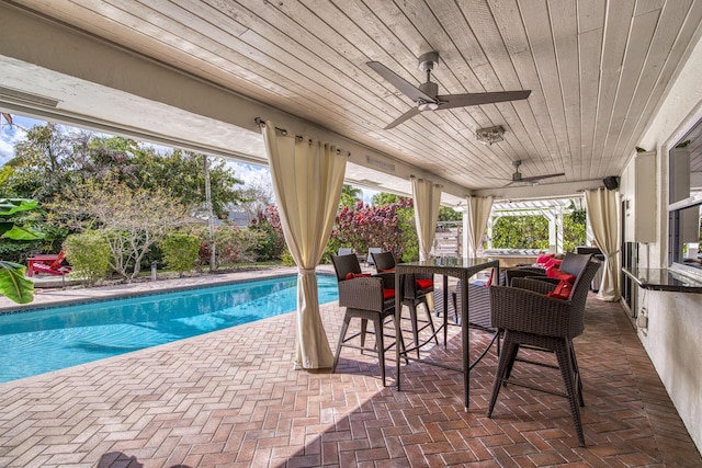 view of swimming pool featuring a patio, outdoor lounge area, and ceiling fan