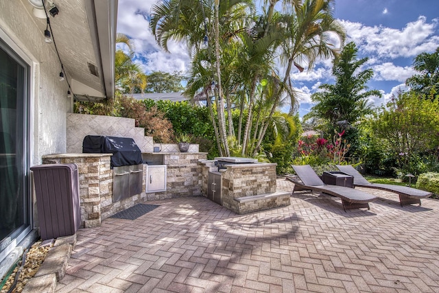 view of patio with exterior kitchen and grilling area