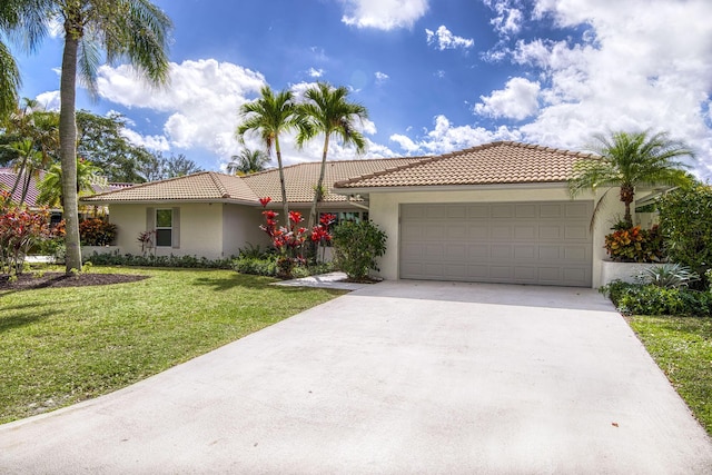 view of front of house with a front yard and a garage