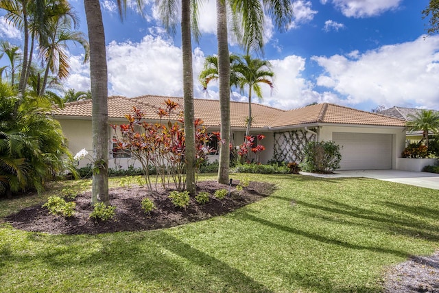 mediterranean / spanish house featuring a front lawn and a garage