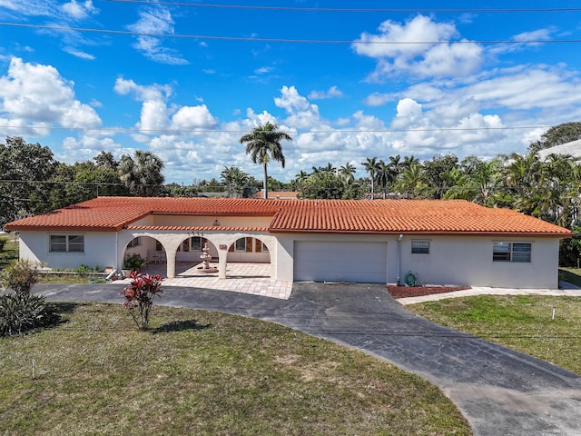 view of front of property with a garage and a front yard