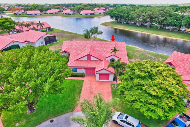 birds eye view of property with a water view