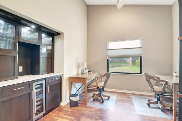 office space featuring wine cooler and light hardwood / wood-style floors