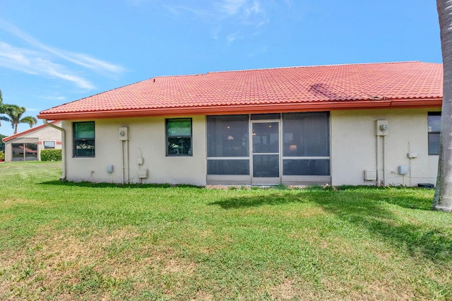 back of property featuring a yard