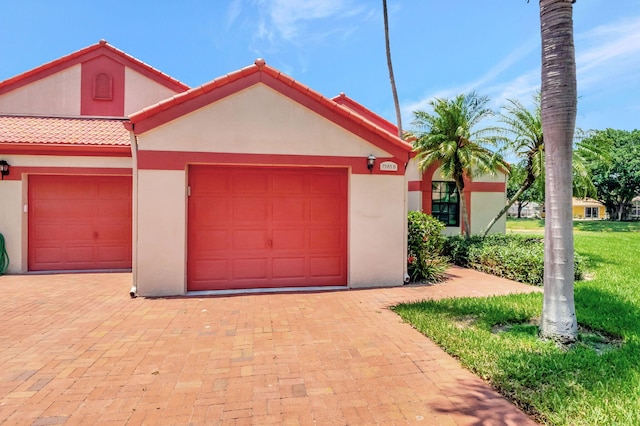 mediterranean / spanish-style house with a garage