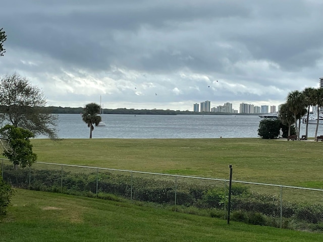 property view of water featuring a view of city and fence