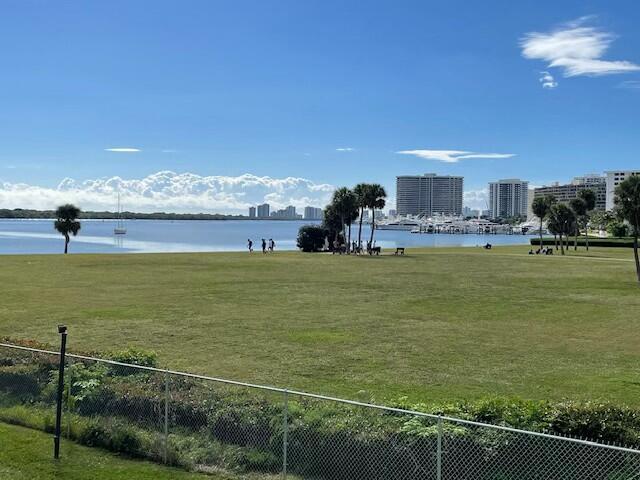 view of water feature featuring a view of city and fence