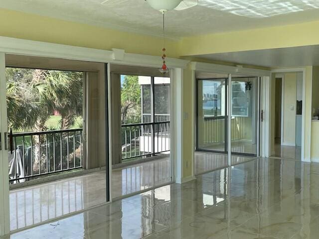 spare room featuring marble finish floor and baseboards