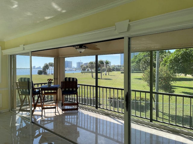 sunroom / solarium featuring ceiling fan