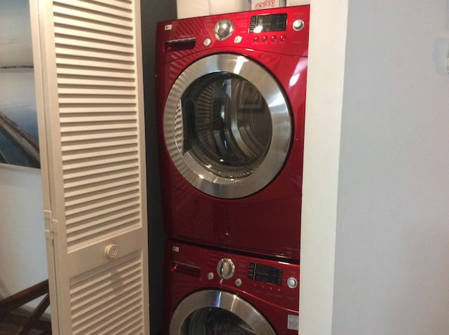 laundry area featuring stacked washer and clothes dryer and laundry area