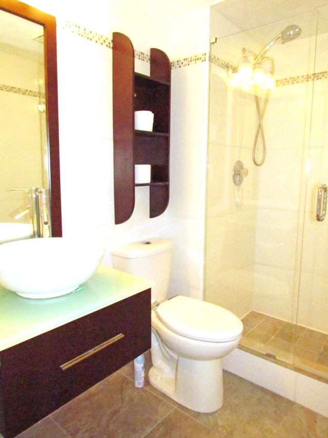 bathroom with vanity, toilet, and a stall shower