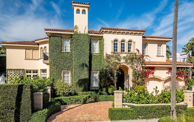 mediterranean / spanish-style home with a balcony