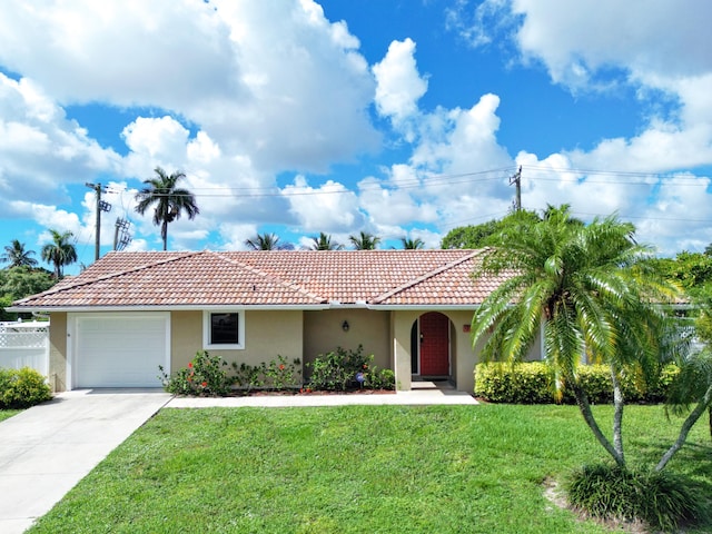 mediterranean / spanish-style home featuring a front lawn, stucco siding, and a tiled roof