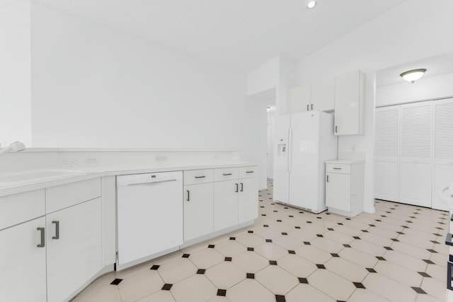 kitchen with white cabinetry, white appliances, and sink