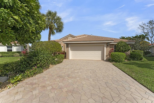 view of front of property with a garage and a front yard