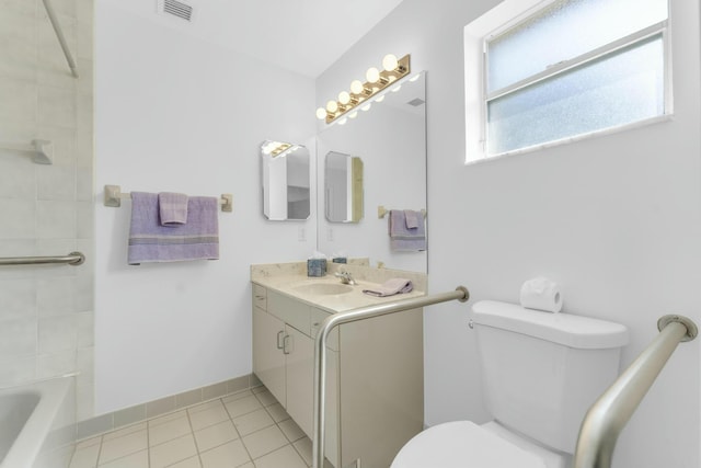 bathroom with vanity, a washtub, tile patterned floors, and toilet