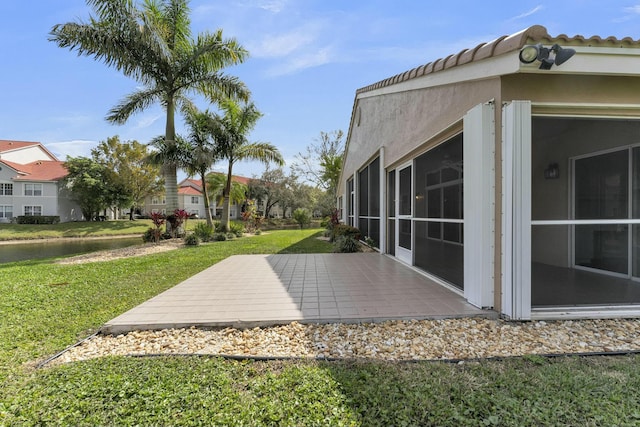 view of yard featuring a patio area and a sunroom