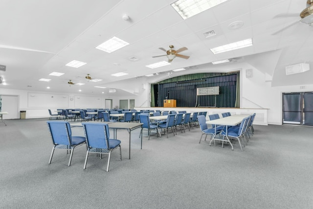 carpeted dining space with ceiling fan