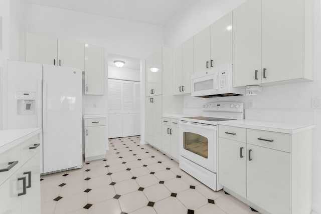 kitchen featuring white cabinetry and white appliances