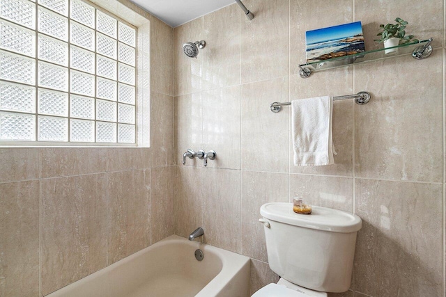 full bath featuring tile walls, toilet, and shower / washtub combination