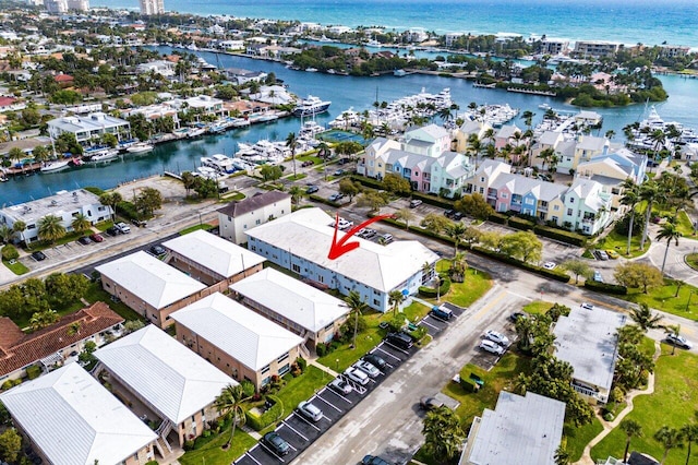 drone / aerial view featuring a residential view and a water view