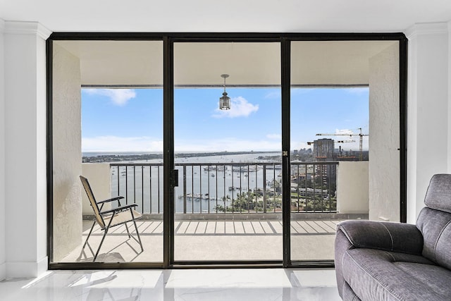 interior space featuring a water view and floor to ceiling windows