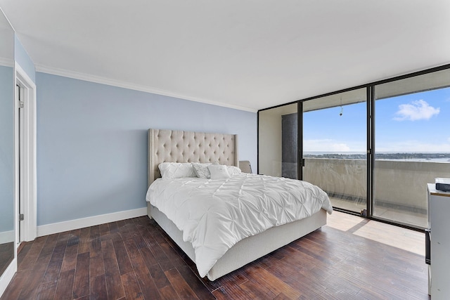 bedroom with crown molding, hardwood / wood-style floors, and a wall of windows