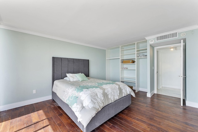 bedroom with dark hardwood / wood-style flooring and crown molding