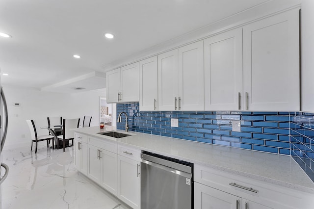 kitchen with sink, dishwasher, light stone countertops, white cabinets, and decorative backsplash